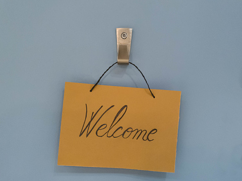 Welcome sign hanging on wall