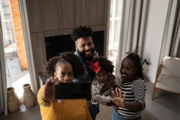 istock Family using mobile phone doing a video call or a selfie at home 1309471813