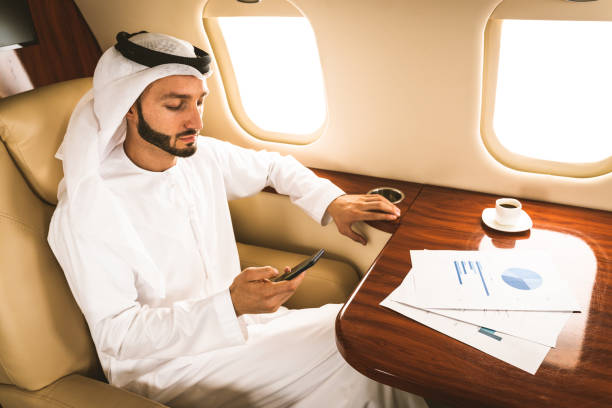 istock Arabian man wearing kandora flying on private jet 1309472144