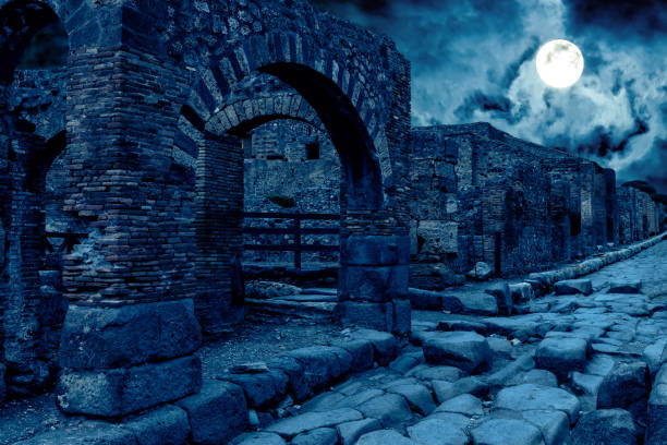 Pompeii at night, Italy. Mystic apocalyptic view of destroyed houses of ancient city in full moon. Pompeii at night, Italy. Mystic apocalyptic view of destroyed houses of ancient city in full moon. Spooky dark scene for Halloween theme. Concept of history, mystery, ruins and creepy deserted place. ancient roman civilization stock pictures, royalty-free photos & images