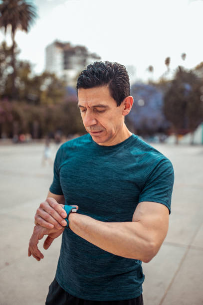 istock Senior athlete looking at smart watch 1309473113