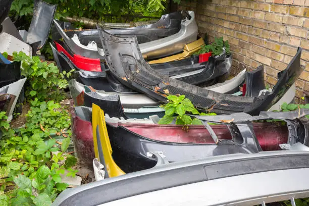 Photo of Scrapyard of bumpers. Motor-car dump, cemetery.