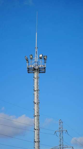 istock High lighting mast against the blue sky. View from below. Full height. 1309475254