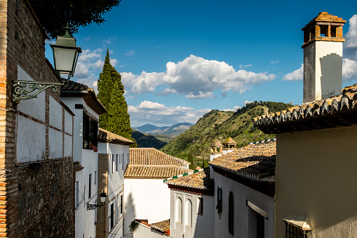 Albaicín neighborhood. Facades of houses and Sierra Nevada in the distance.