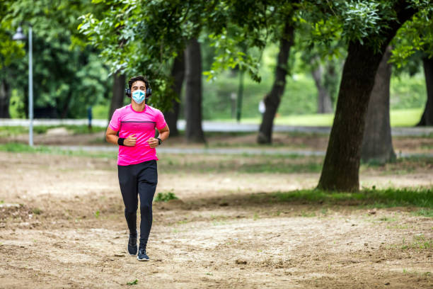 istock Man runner wearing medical mask. 1309476164