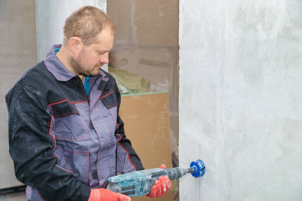 istock An electrician drills holes for sockets with a diamond core bit 1309476538