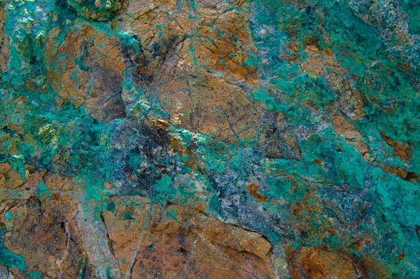 closeup of copper mineralization. a rock showing signs of copper and gold. copper mine photos stock pictures, royalty-free photos & images