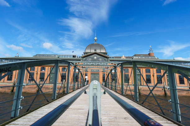 bridge with hamburg fish market in background under blue sky
