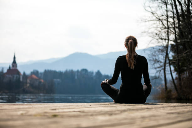 istock Woman practicing yoga poses in nature, lake Bled. 1309479392