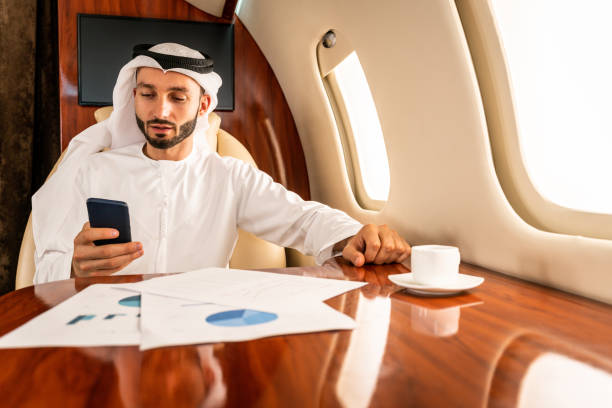 istock Arabian man wearing kandora flying on private jet 1309480235