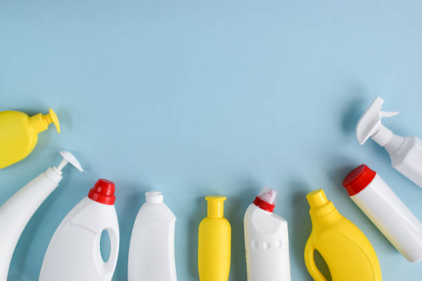 istock White detergent bottles on a blue background. Clean bottles for detergents and cleaning products. Disinfection of the room. A copy of the space. Flat lay 1309481468