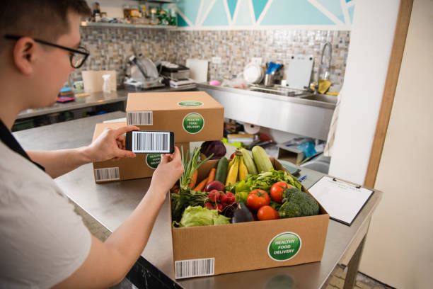 istock Cardboard boxes being filled with food for delivery 1309482484