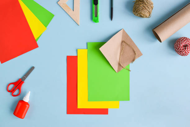 istock Tulips made of colored paper. Step-by-step instructions. Step 1 prepare the colored paper. Top view. Flat lay 1309482579