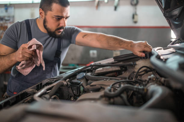istock Mechanic examining car engine in auto repair shop 1309487307