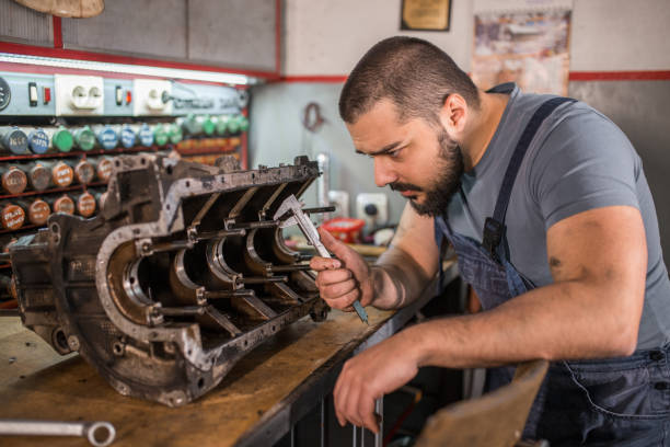 istock Car mechanic analyzing engine in auto repair shop 1309487562