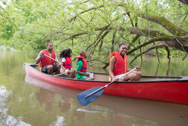 istock African Family Wearing Life Jackets While Canoeing 1309489726