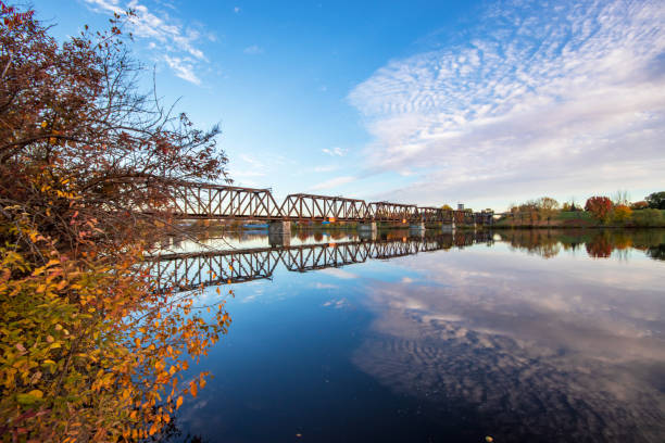 istock Bridge reflecting in a river in Autumn 1309491879