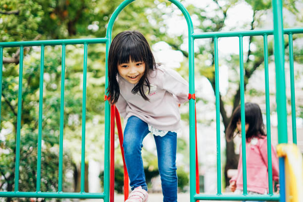 istock Little girl playing on the slide 1309492821