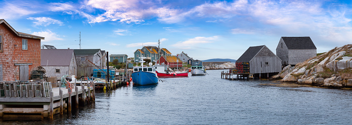 Scenic View of a small town near a rocky coast on the Atlantic Ocean. Colorful Blue Sky Art Render. Peggys Cove, near Halifax, Nova Scotia, Canada.