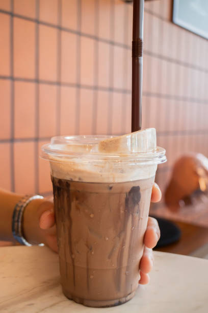 istock Hand  holding the glass iced cocoa 1309505775