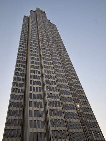 Low angle view of St. John's Building, a skyscraper in Central on Hong Kong Island of Hong Kong.  The ground floor serves as the Garden Road terminus of the Peak Tram.