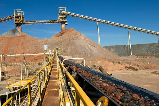 Ore transport to crusher. long convey belt transports the ore to a crusher in this gold and copper mine in Australia. mining conveyor belt stock pictures, royalty-free photos & images