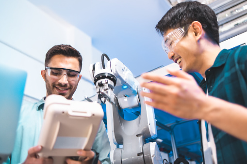 Team of engineers are conducting an experiment with robots.Close Up of a Futuristic Prosthetic Robot Arm Being Tested by a Professional Development Engineer
