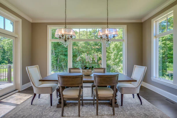 istock Elegant dining room enclosed by large windows 1309517093