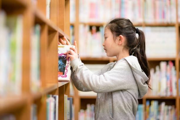 istock Girl choosing a book 1309518618