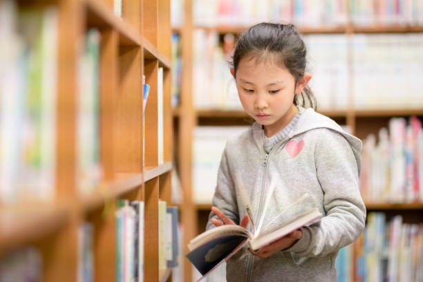 istock Girl choosing a book 1309518622