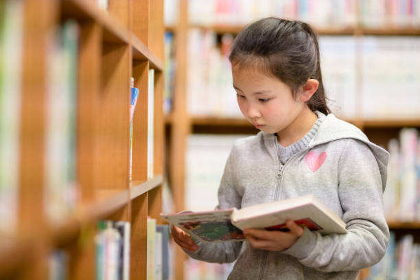 istock Girl choosing a book 1309518632