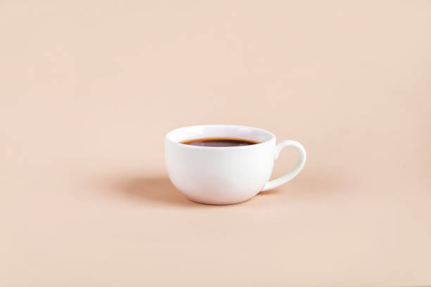 istock White cup with black coffee espresso on color background. Minimalism, Copy space for text. 1309519340