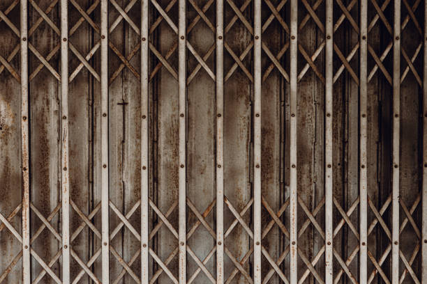 istock Old grunge rusty shutter folding door for shop closed or business down concept, texture pattern or steel gate. 1309522156
