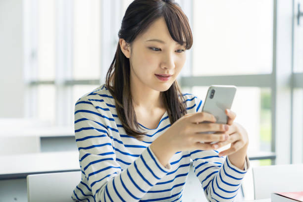 istock Young asian female student using a smart phone. 1309523829