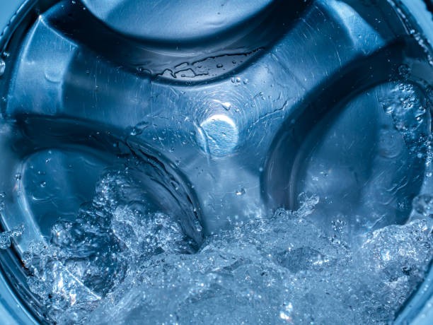 Rotating drum in the washing machine tub with water. Rotating drum in the washing machine tub with water. Washer. Automatic laundry. Service and repair of equipment. Splashing water. Repair shop. Stainless steel tank. Centrafuga. washing machine drum stock pictures, royalty-free photos & images