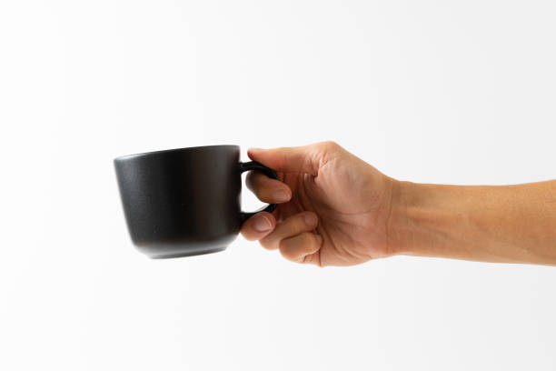 istock hand holding black color cup coffee on white background 1309525306