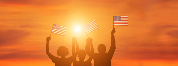istock USA flag on sky background. American holidays 1309526217