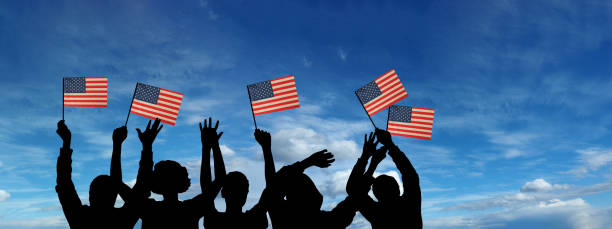 istock USA flag on sky background. American holidays 1309526226