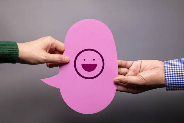 istock Customer Experience Concept. Happy Client giving a Smiling Emoticon to a Businessman. Feedback on Bubble Speech Card. Positive Review. Satisfaction Survey 1309526298