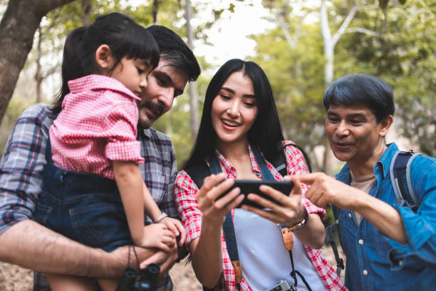 istock happy family with backpac.ks taking selfie by smartphone and hiking 1309528126