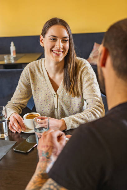 istock Friends sitting in coffee bar and talking 1309530057