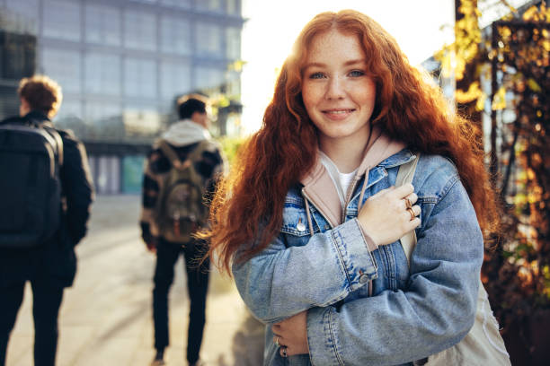 istock Girl standing outside college 1309530301
