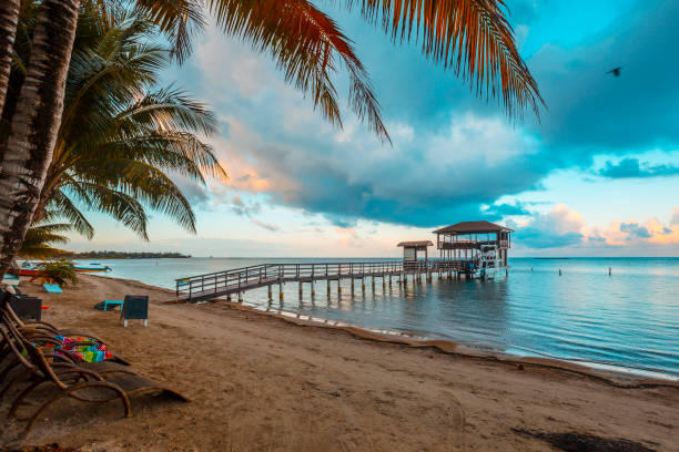 Roatán, Honduras »; January 2020: A pier at Sandy Bay beach on Roatan Island stock photo