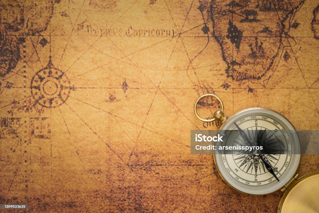 Old compass on vintage map Old compass on vintage map with copy space Map Stock Photo