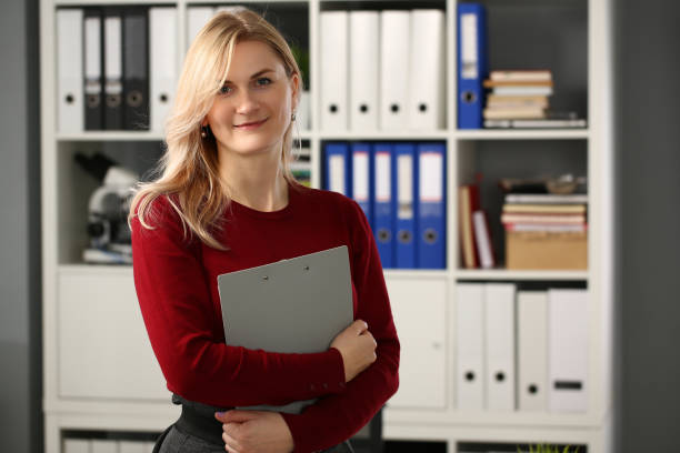 istock Positive delighted blonde woman looking at camera 1309534828
