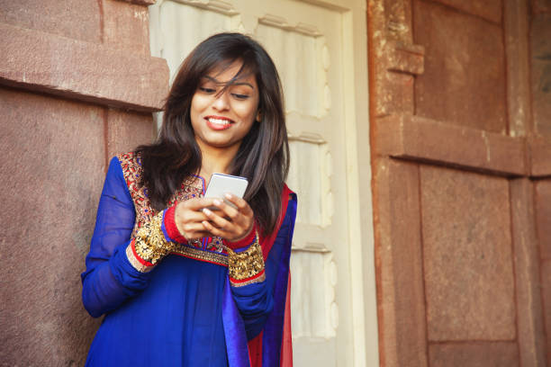 istock Young indian woman with smartphone 1309535638
