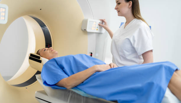 istock Doctor Preparing Patient For CT Scanner 1309538202