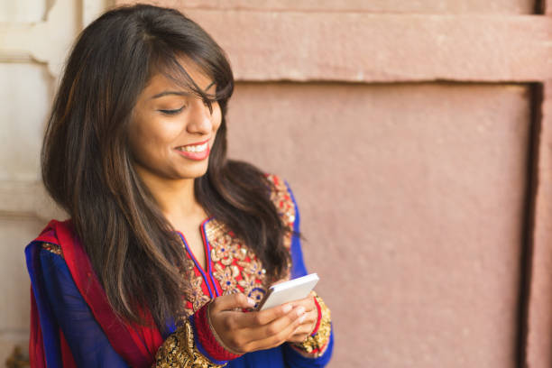 istock Young indian woman with smartphone 1309538207