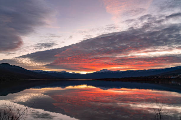 istock Sunset on the lake with snowy mountains in the background 1309538962