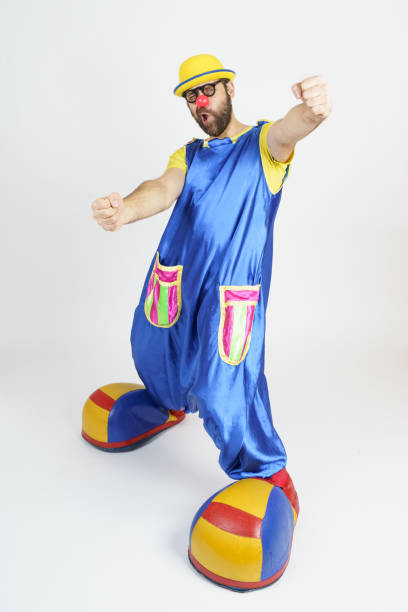 istock A clown in a bright blue and yellow suit virtually driving a car 1309539860